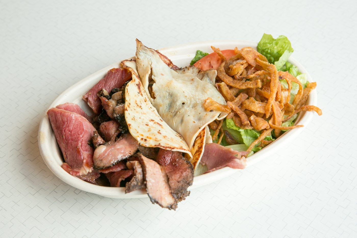 Pastrami platter with salad and crispy onions